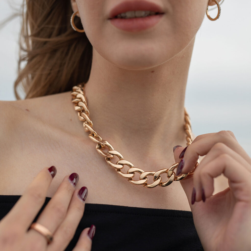 Girl with Gold Chain necklace questioning whether to use homemade jewelry cleaner.